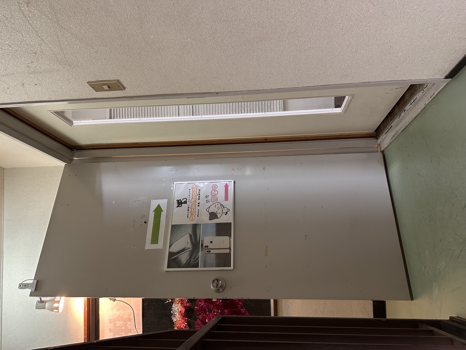 3階の踊り場にある右側の白い扉