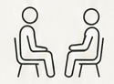 向かい合って説明を受ける二人のアイコン